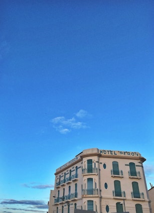 Exterior view of a charming hotel building with traditional architecture under a clear sky.