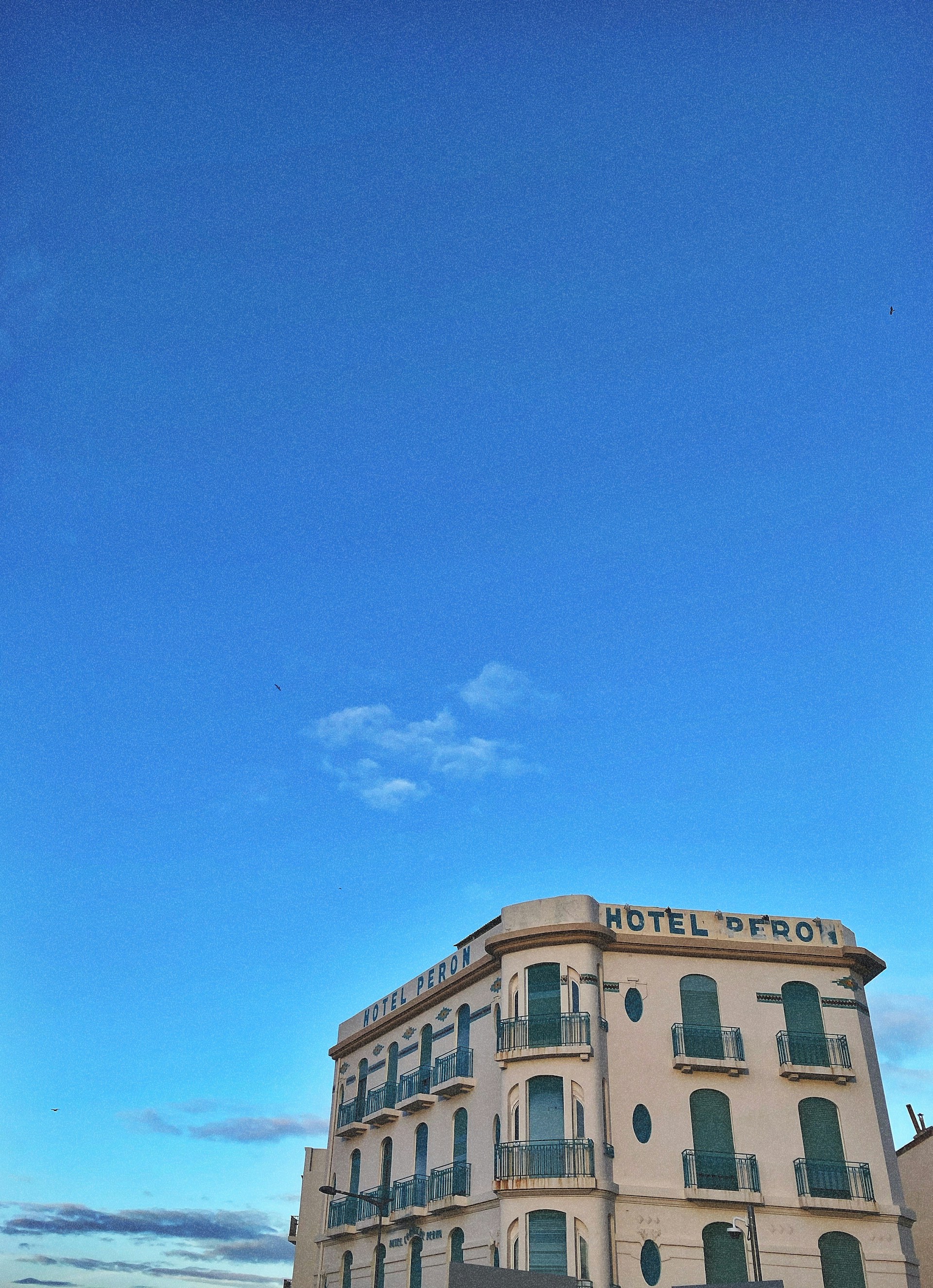 woman wearing yellow long-sleeved dress under white clouds and blue sky during daytime