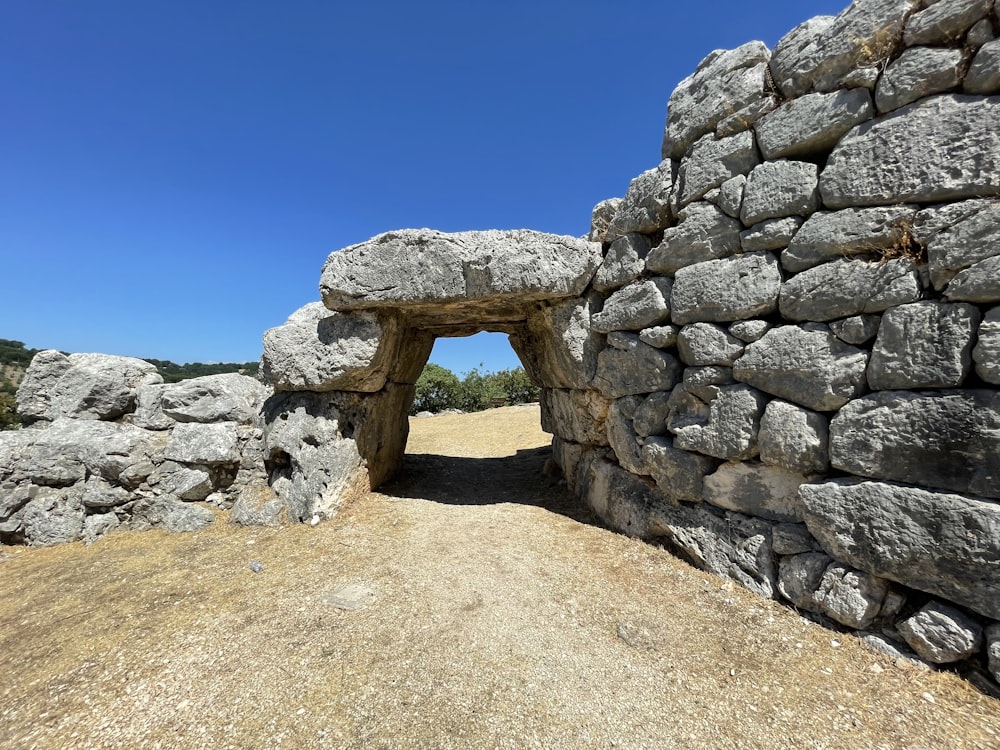 a stone wall with a stone arch