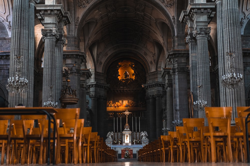 a large room with rows of chairs and a statue in the middle