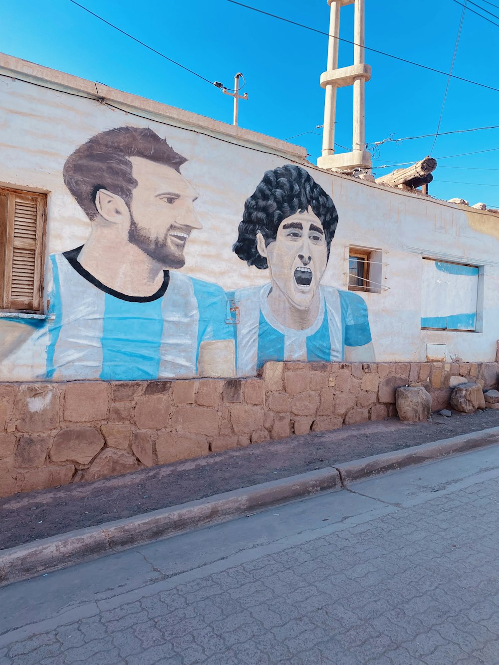 a wall with a mural of men