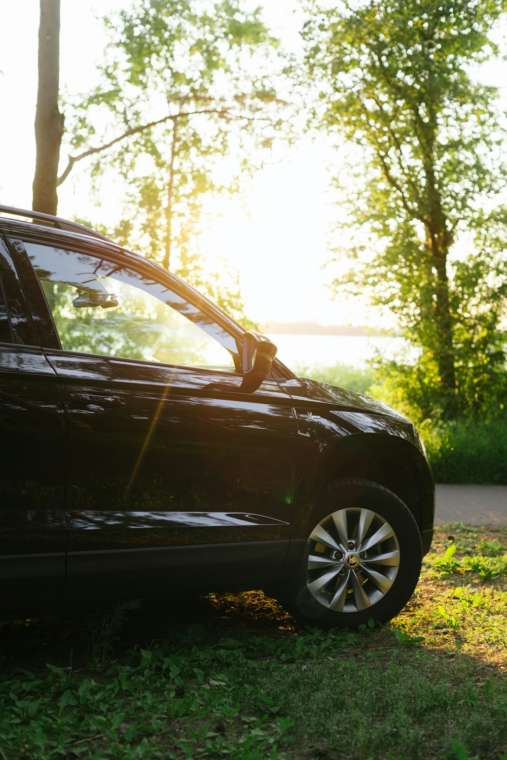 a black car parked on grass