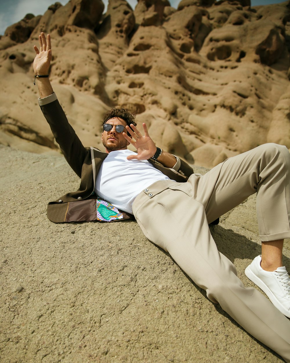 a person lying on the ground with the hands up