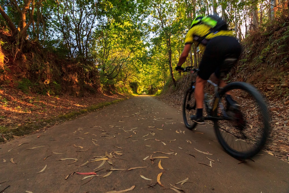 a person riding a bike on a trail in the woods