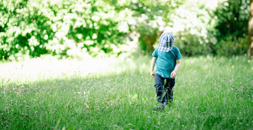 a child walking in a grassy area