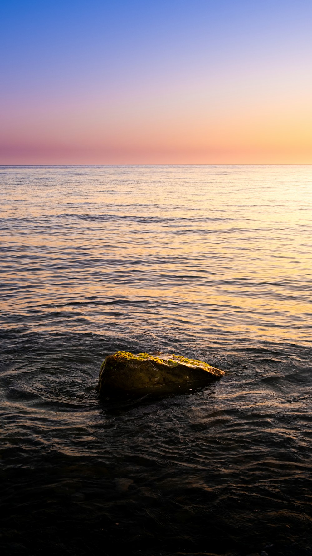 a rock in the middle of the ocean