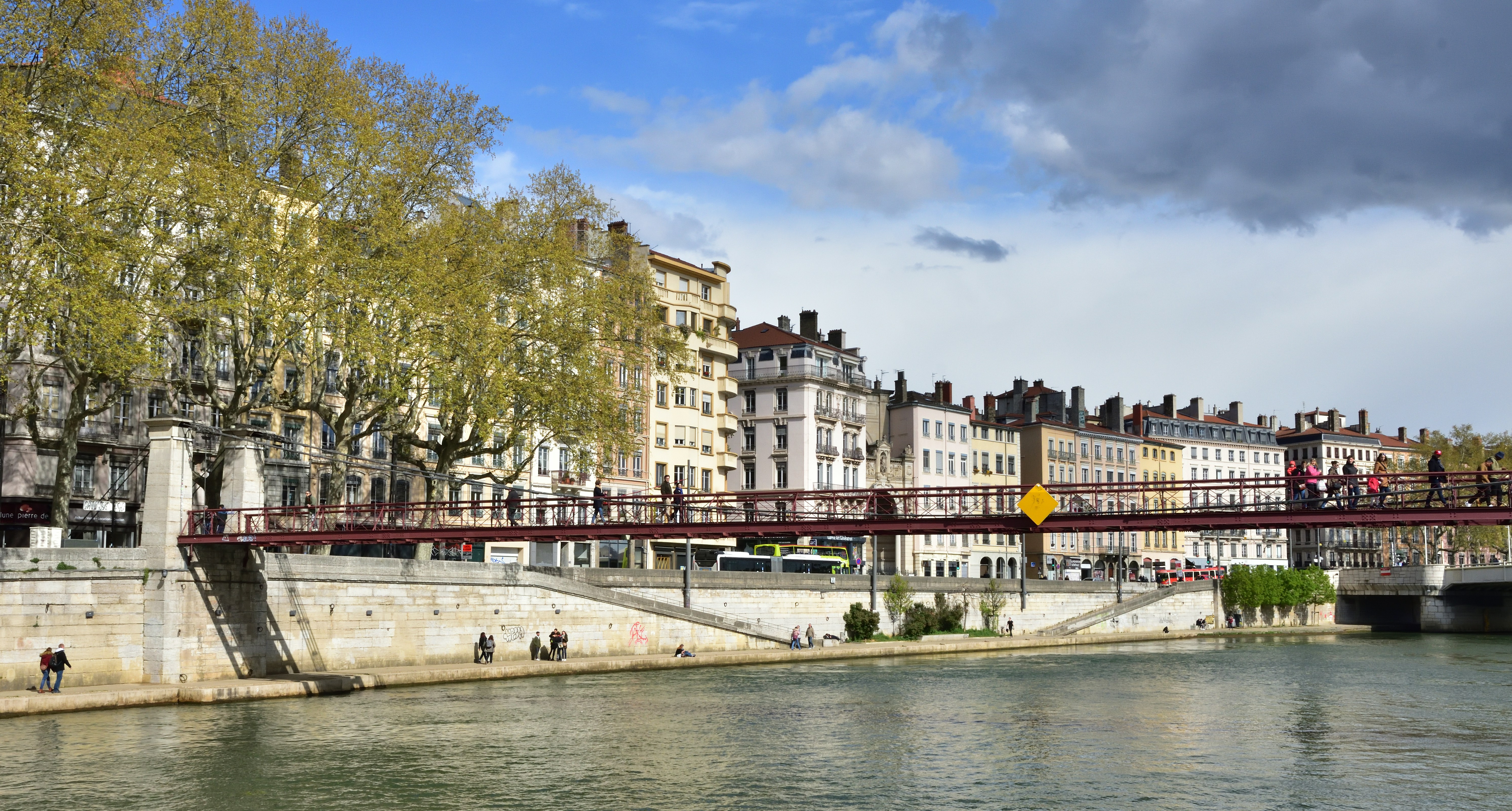 a bridge over a river with buildings on either side of it, 