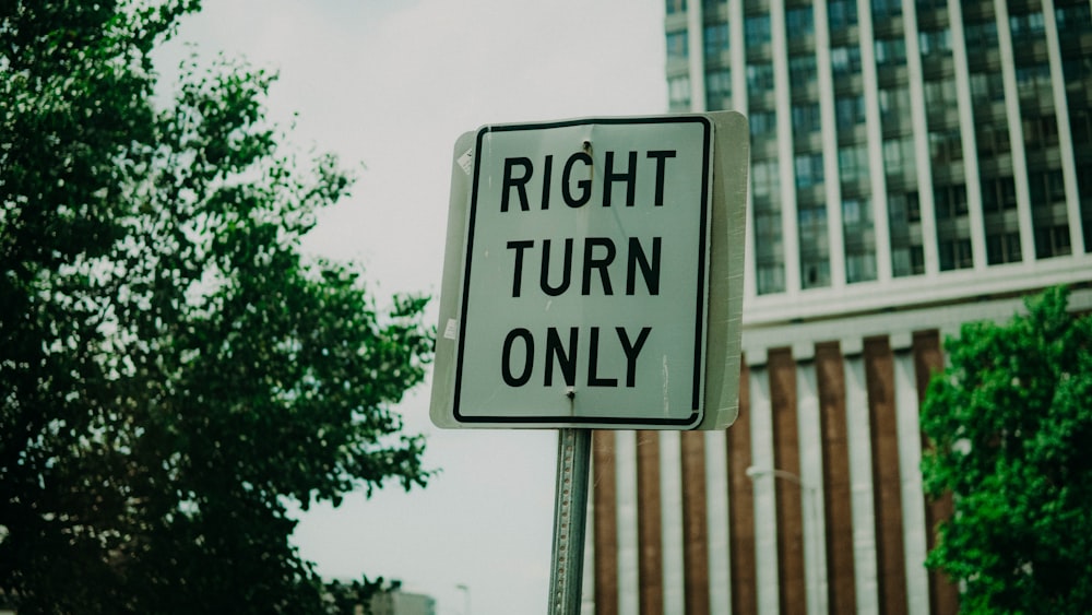 a close up of a street sign on a pole