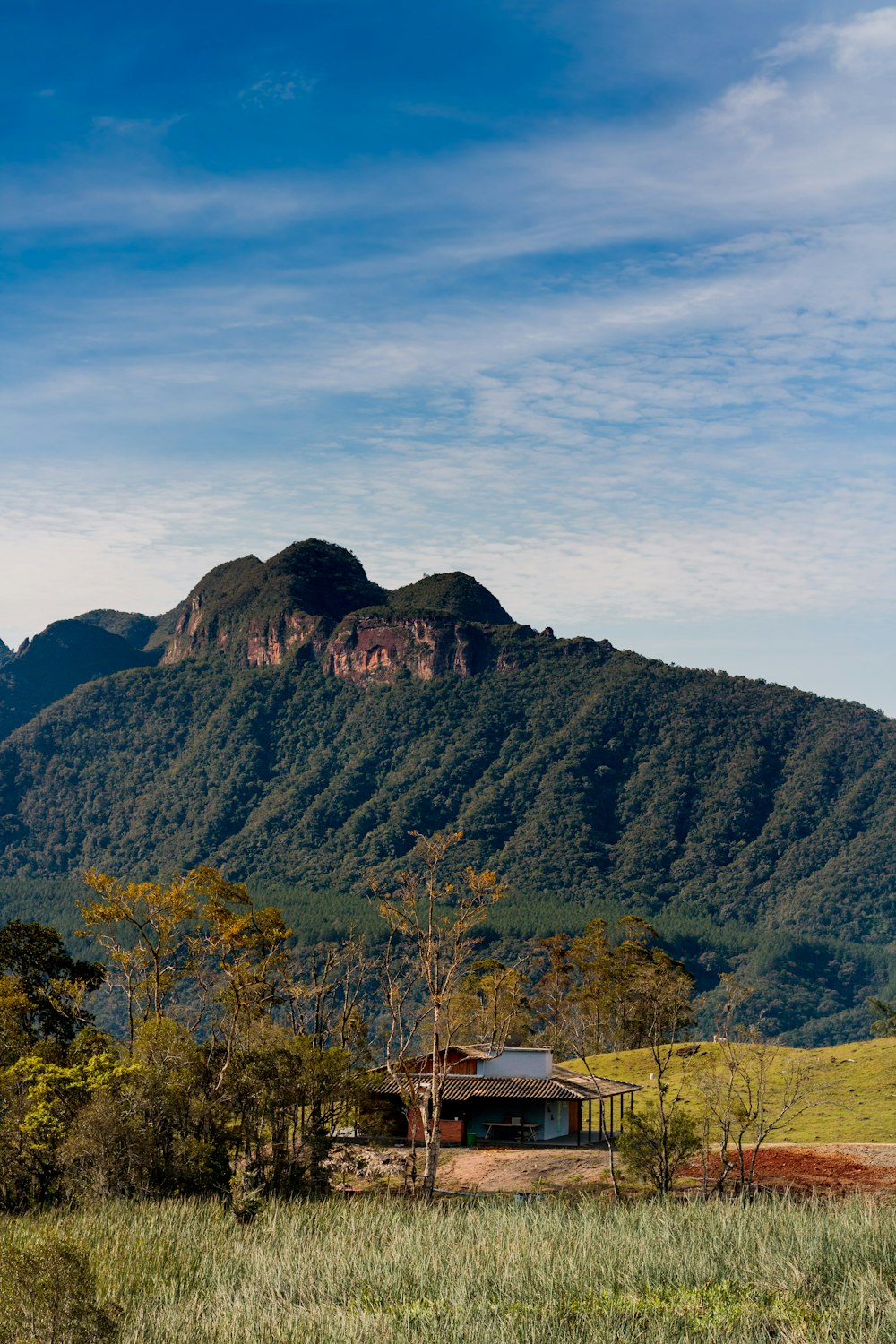 a house in front of a mountain