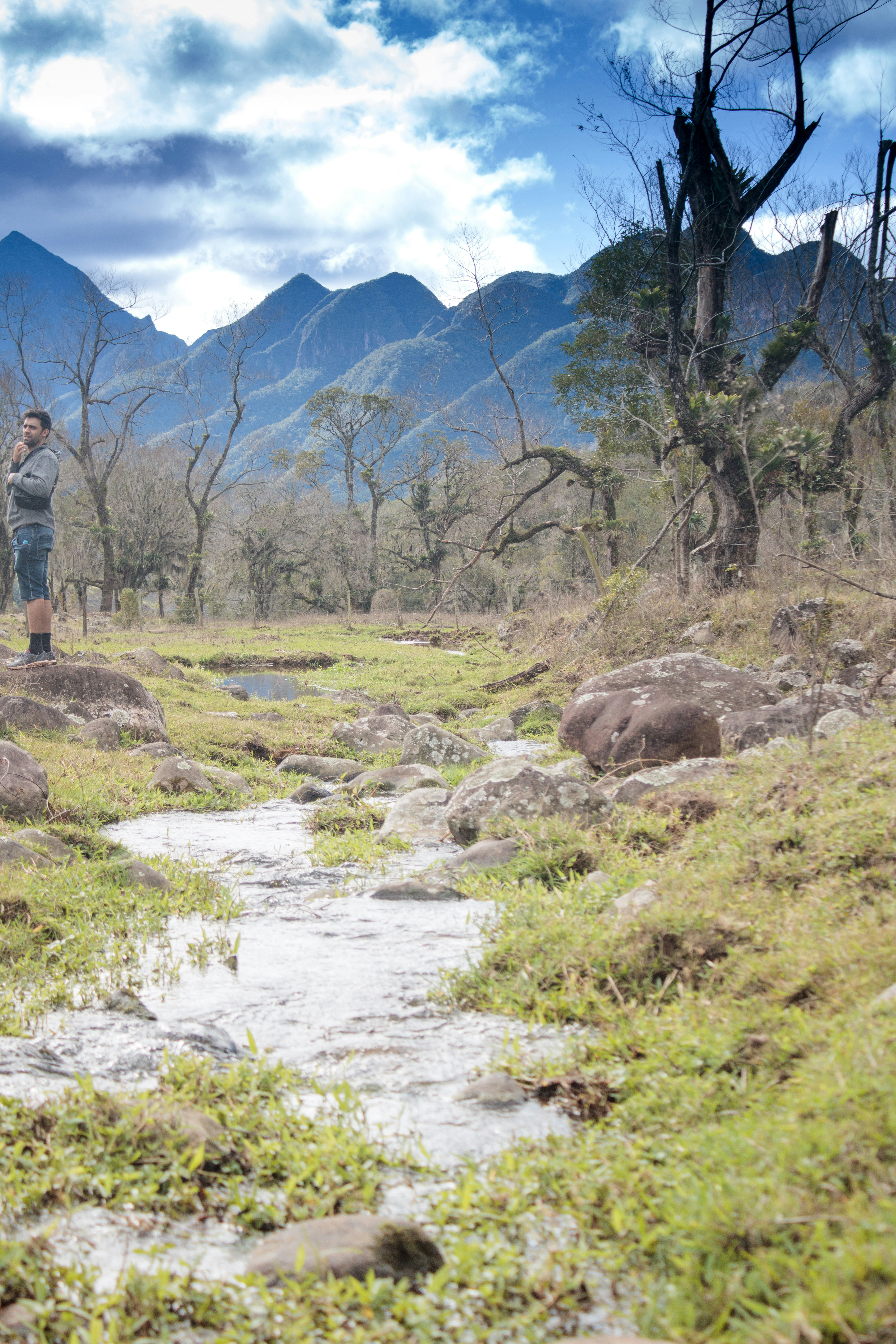 a person standing on a rocky hillside