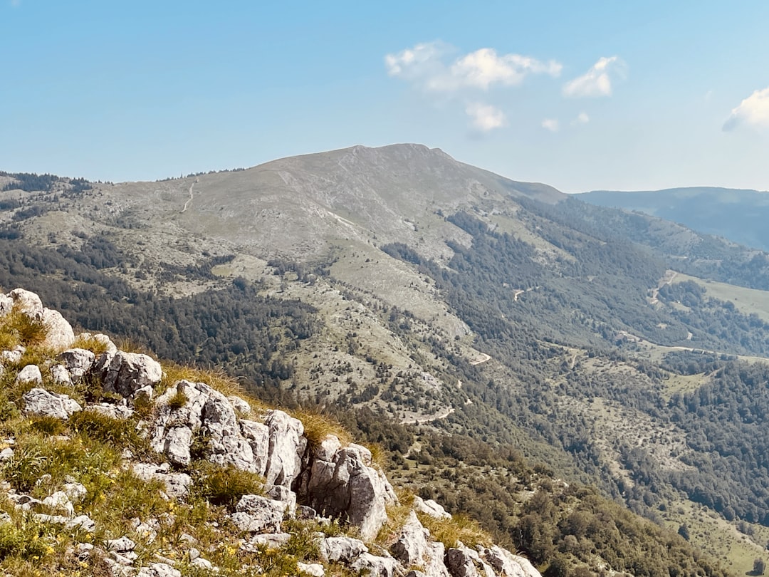 a rocky hillside with a valley below,
