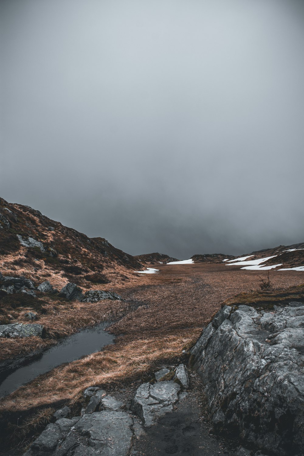 a rocky landscape with a river running through it