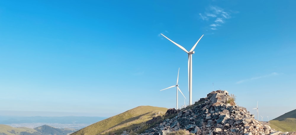 a group of wind turbines on a hill