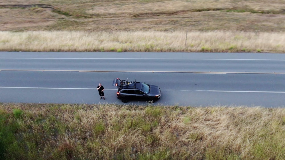 a person standing next to a race car on a race track