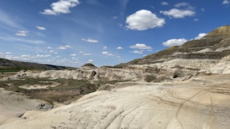 a landscape with hills and a blue sky