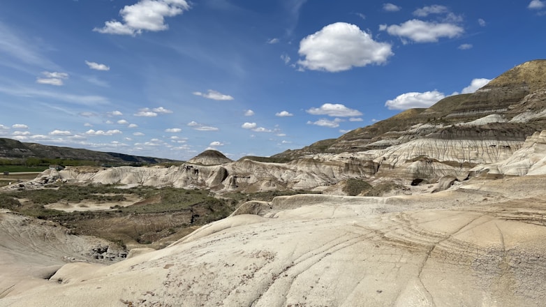 a landscape with hills and a blue sky
