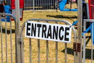 Picture of the exhibition gate with a sign showing ticket prices.