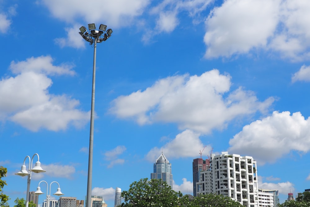 a street light with buildings in the background