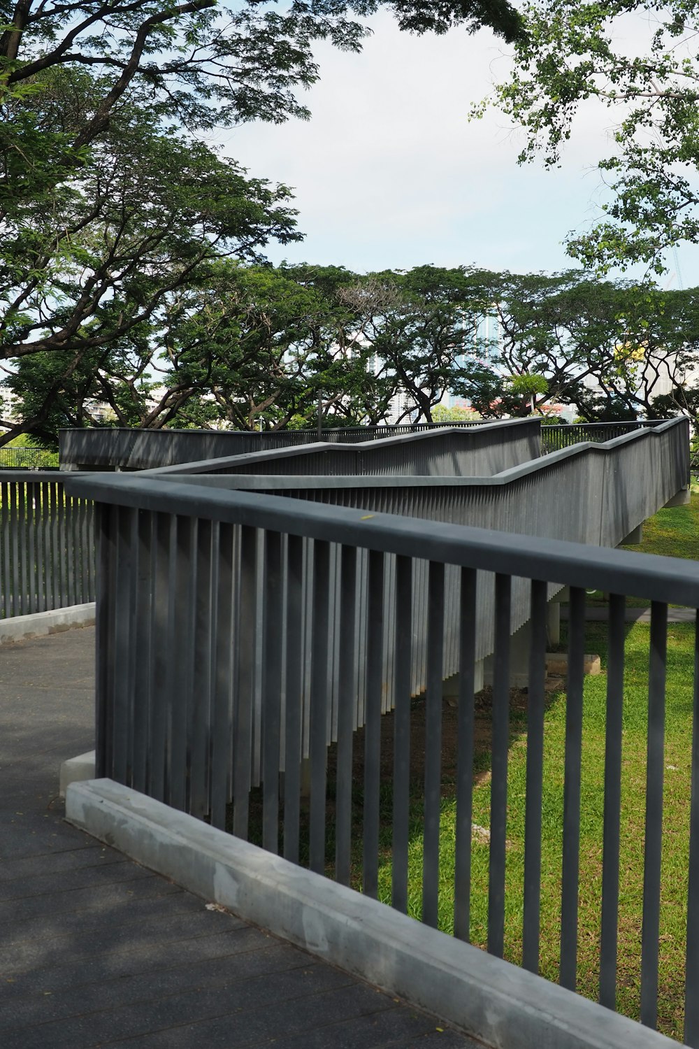 a metal fence with trees in the background