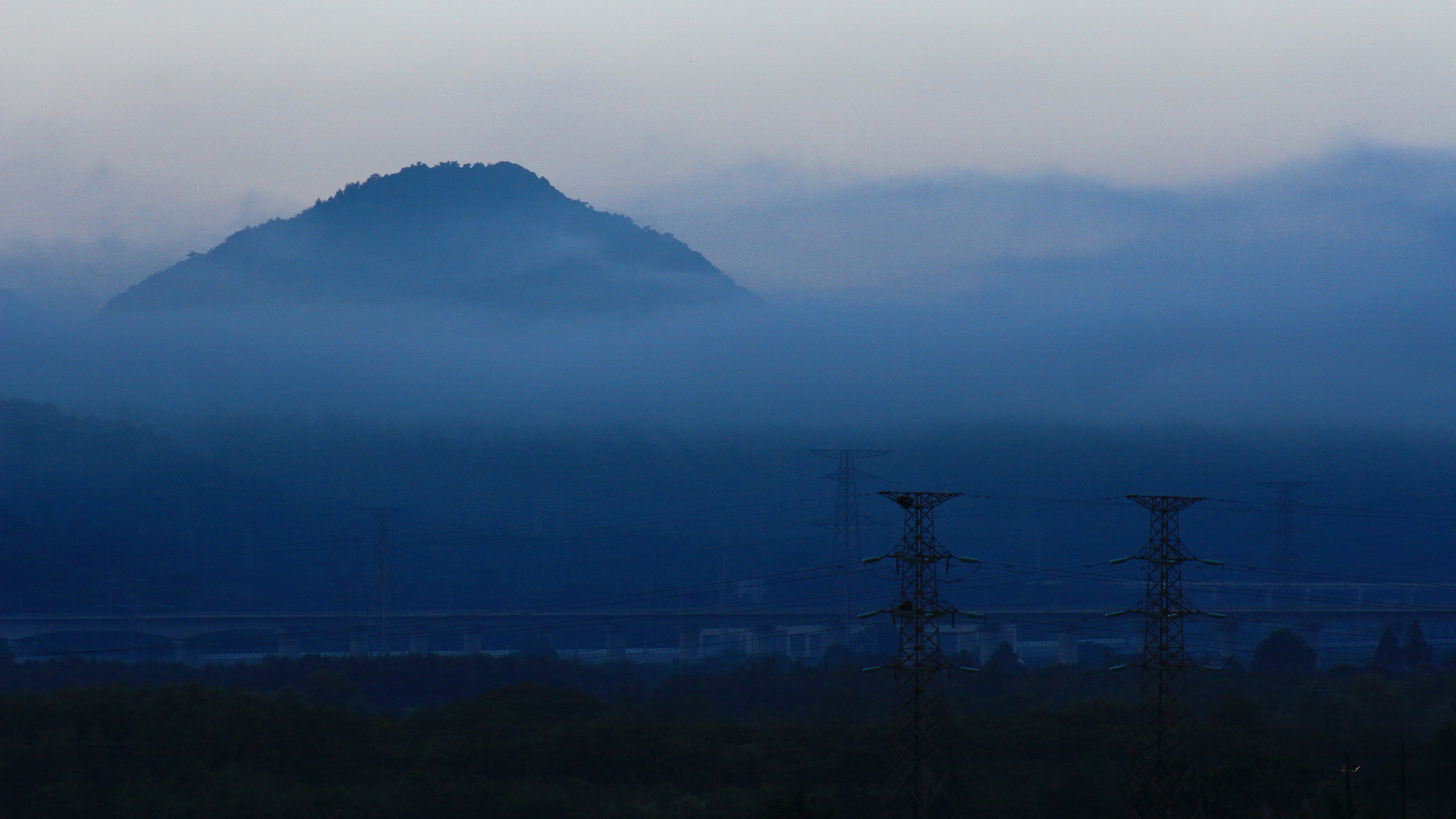 power lines and a mountain in the distance