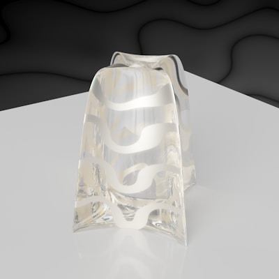 A transparent glass object with a wavy, abstract white pattern running vertically across it, placed on a reflective surface. The background features a smooth, dark gradient with subtle wave-like textures creating a modern and minimalistic setting.