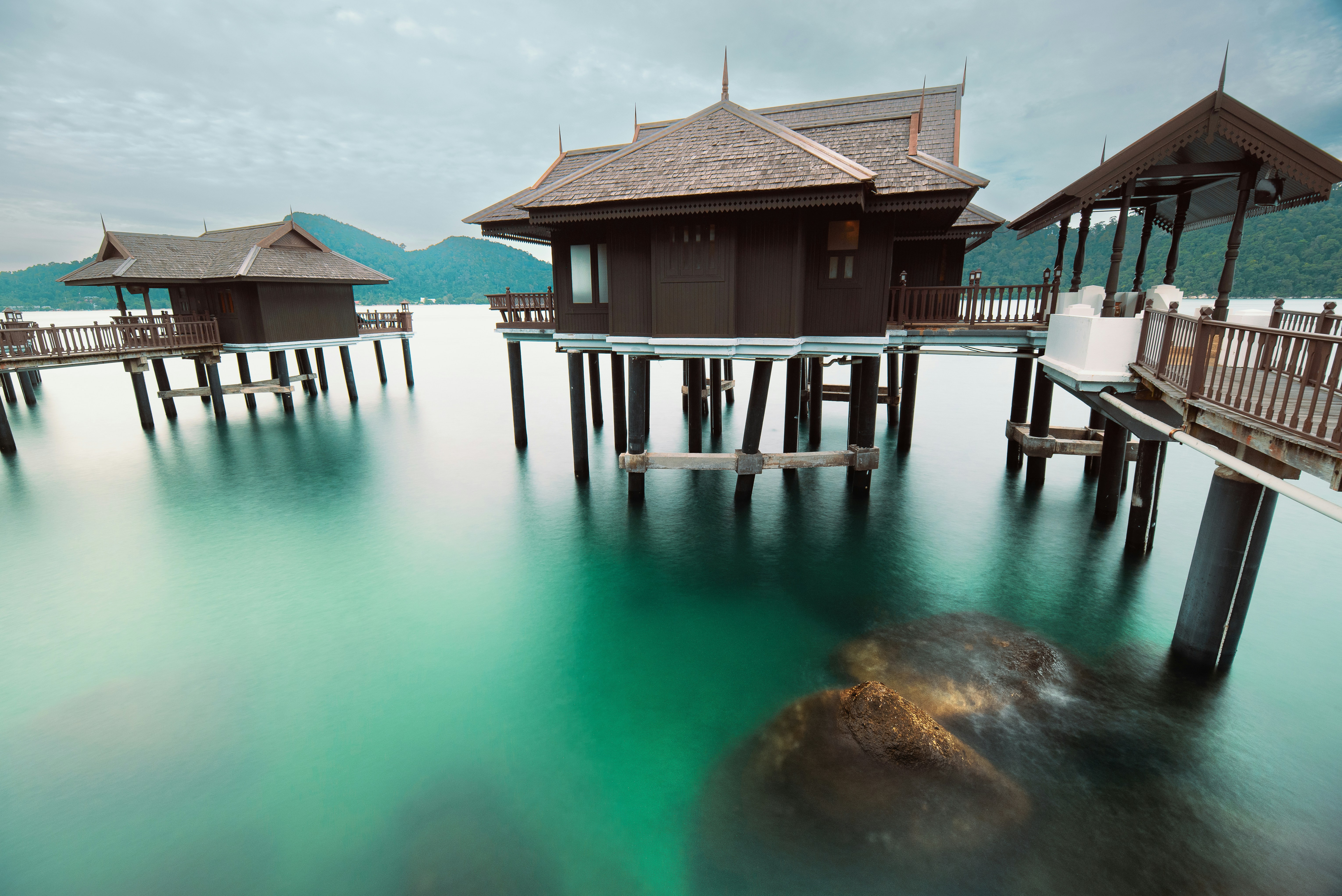 a group of buildings on a dock over water