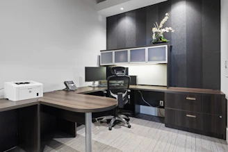 a desk with a chair and a printer on it