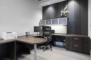 a desk with a chair and a printer on it