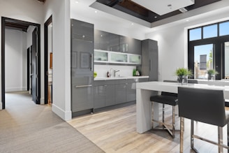 a kitchen with a bar stool and a table