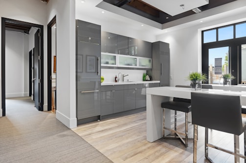 a kitchen with a bar stool and a table