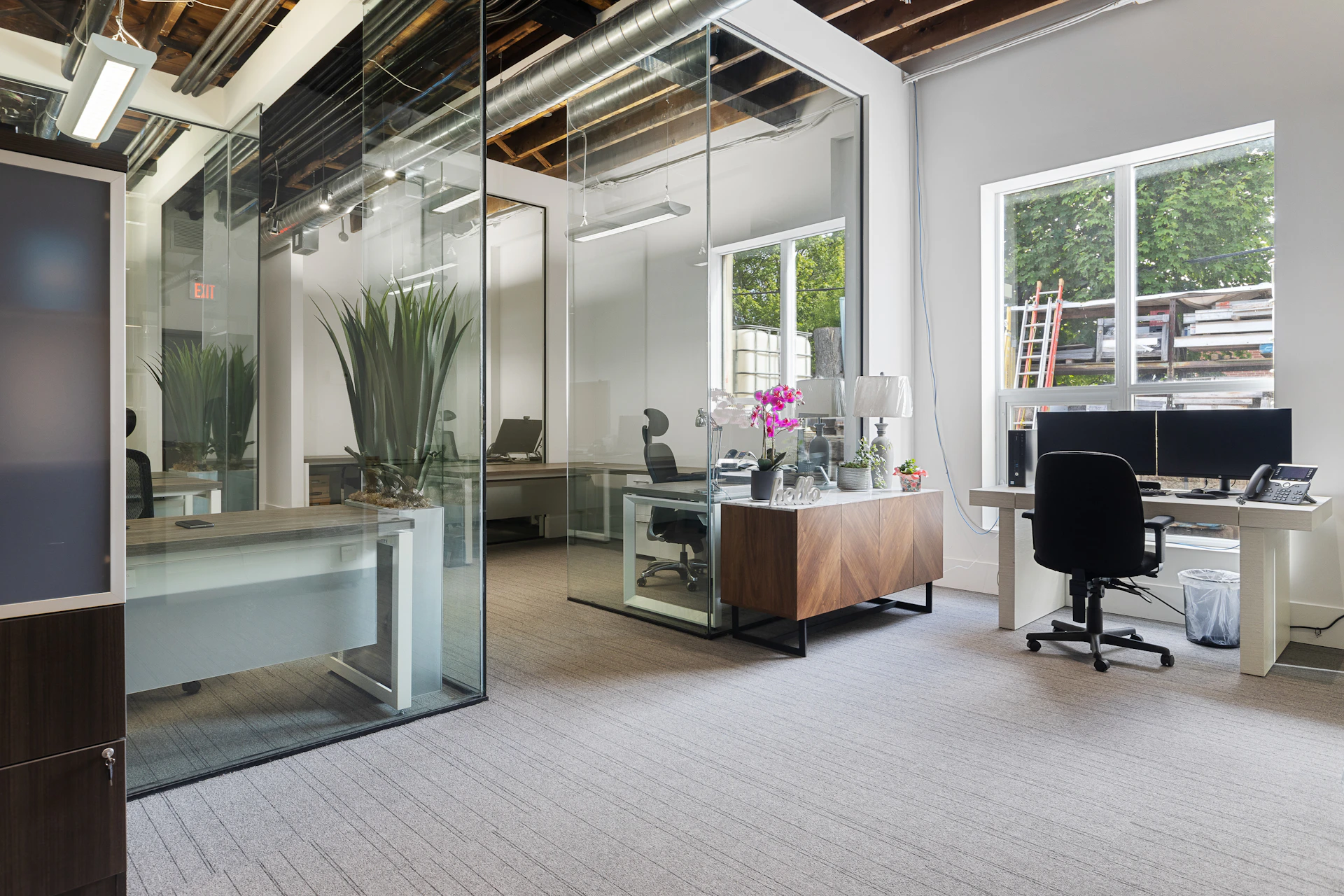 a room with a desk and chairs