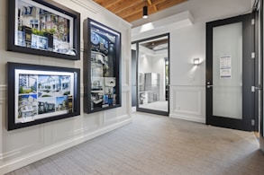 a room with several framed pictures