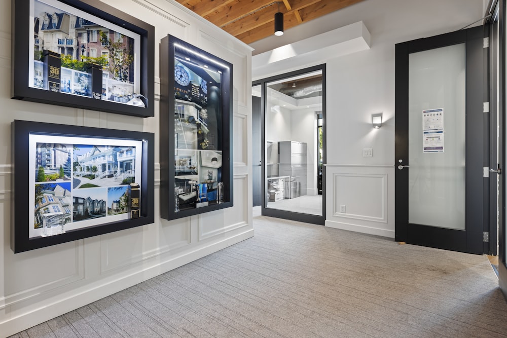 a room with several framed pictures