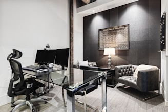 a room with a desk and computer