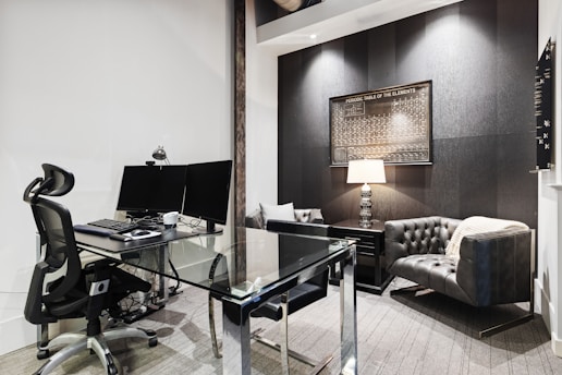 a room with a desk and computer