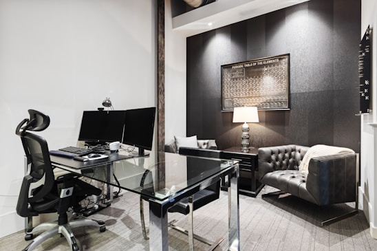 a room with a desk and computer