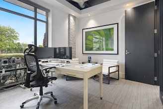 a room with a desk and chairs