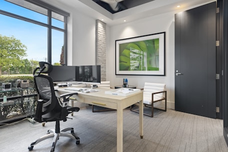 a room with a desk and chairs