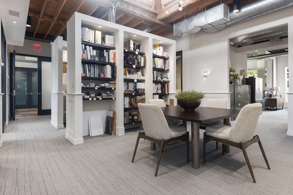 a room with a table chairs and a bookcase