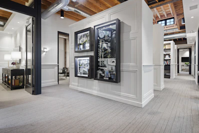 a room with a large display of pictures on the wall