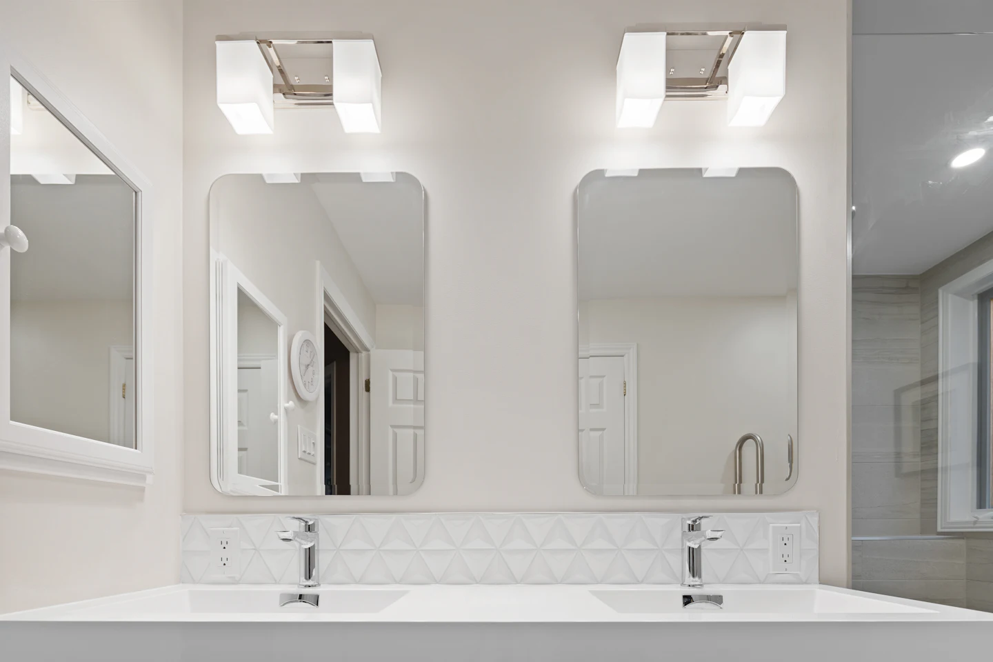 Long double vanity with two mirrors and bright lighting