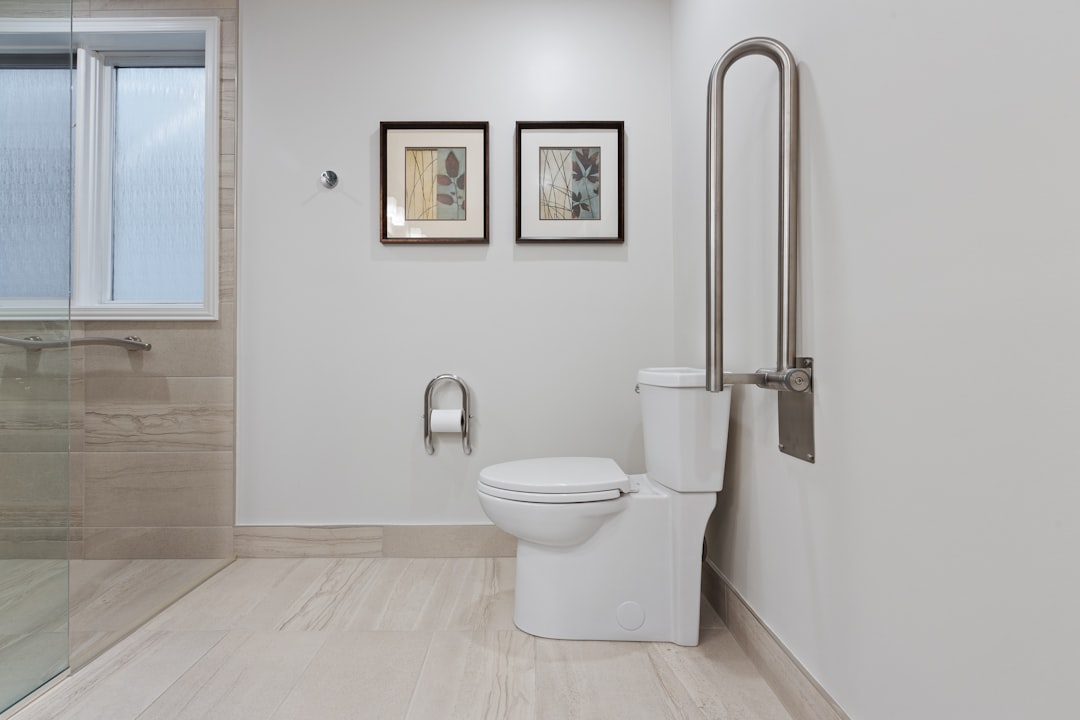 a bathroom with a toilet and a shower,