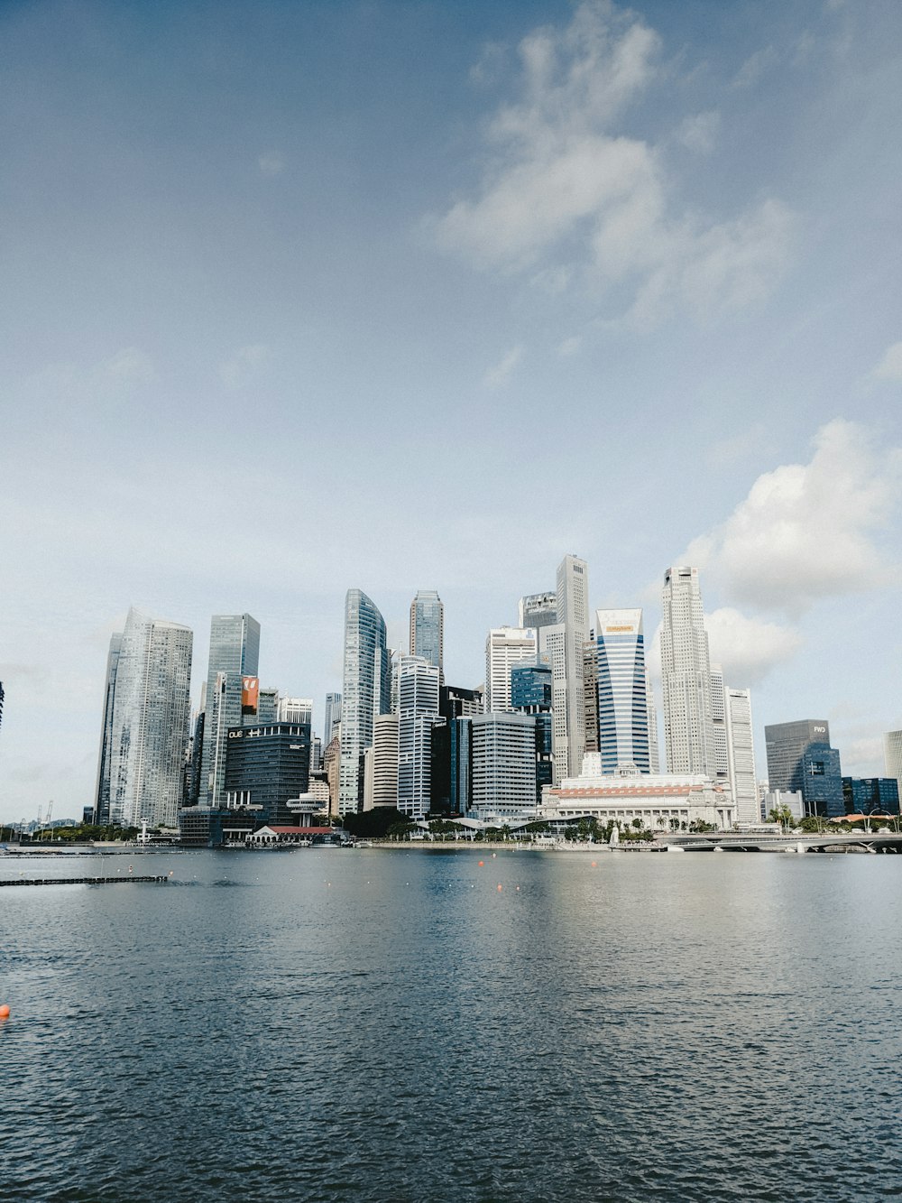 a city skyline with a body of water in the foreground