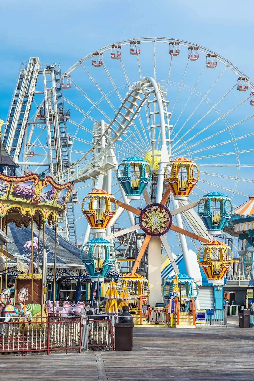 a ferris wheel with a blue sky with Coney Island in the background