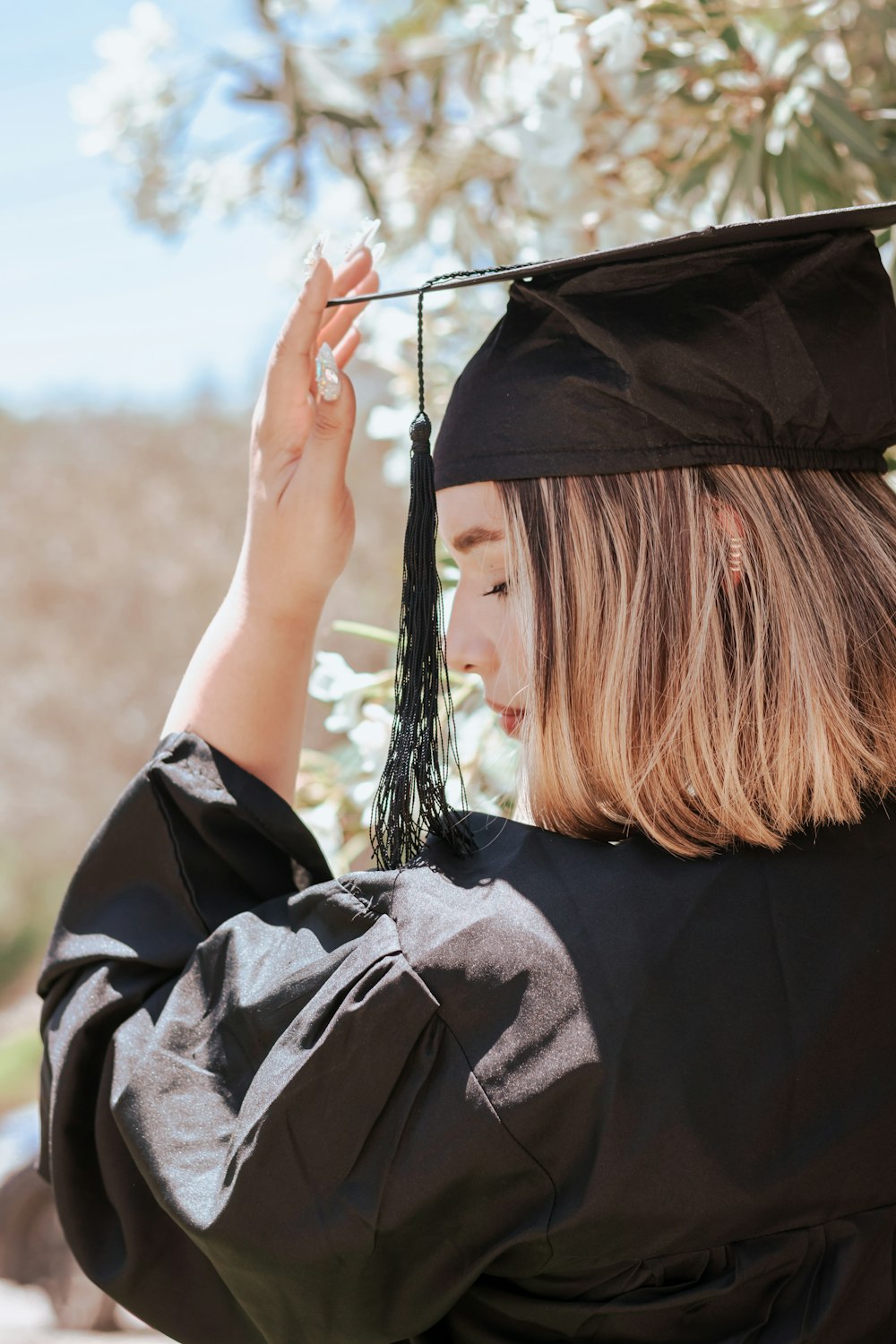 a woman holding a graduation cap