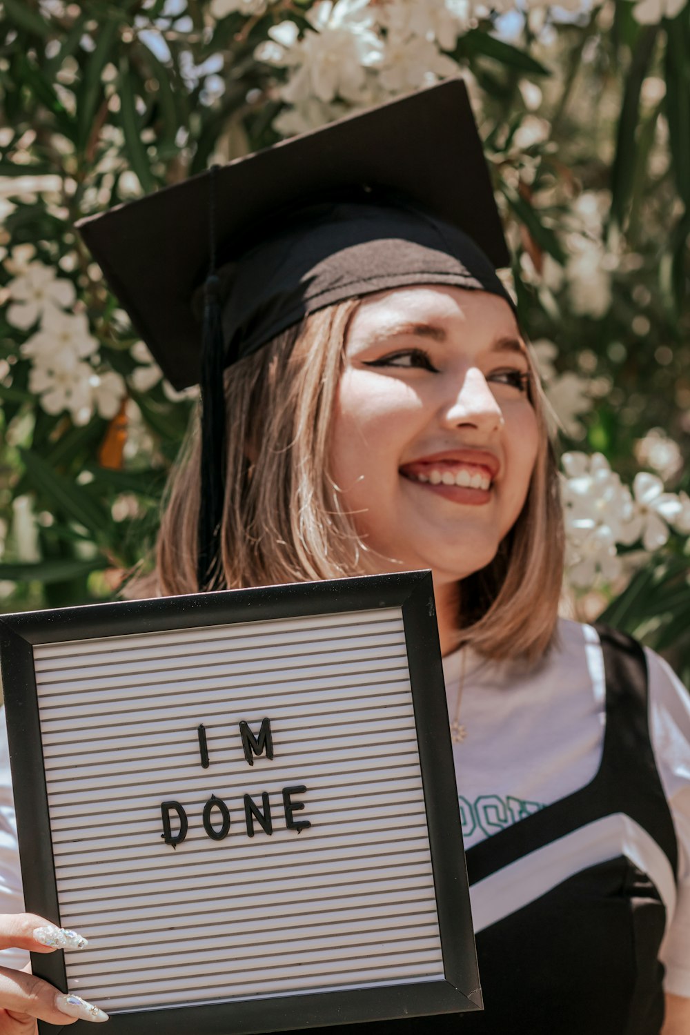 a woman wearing a graduation cap and gown