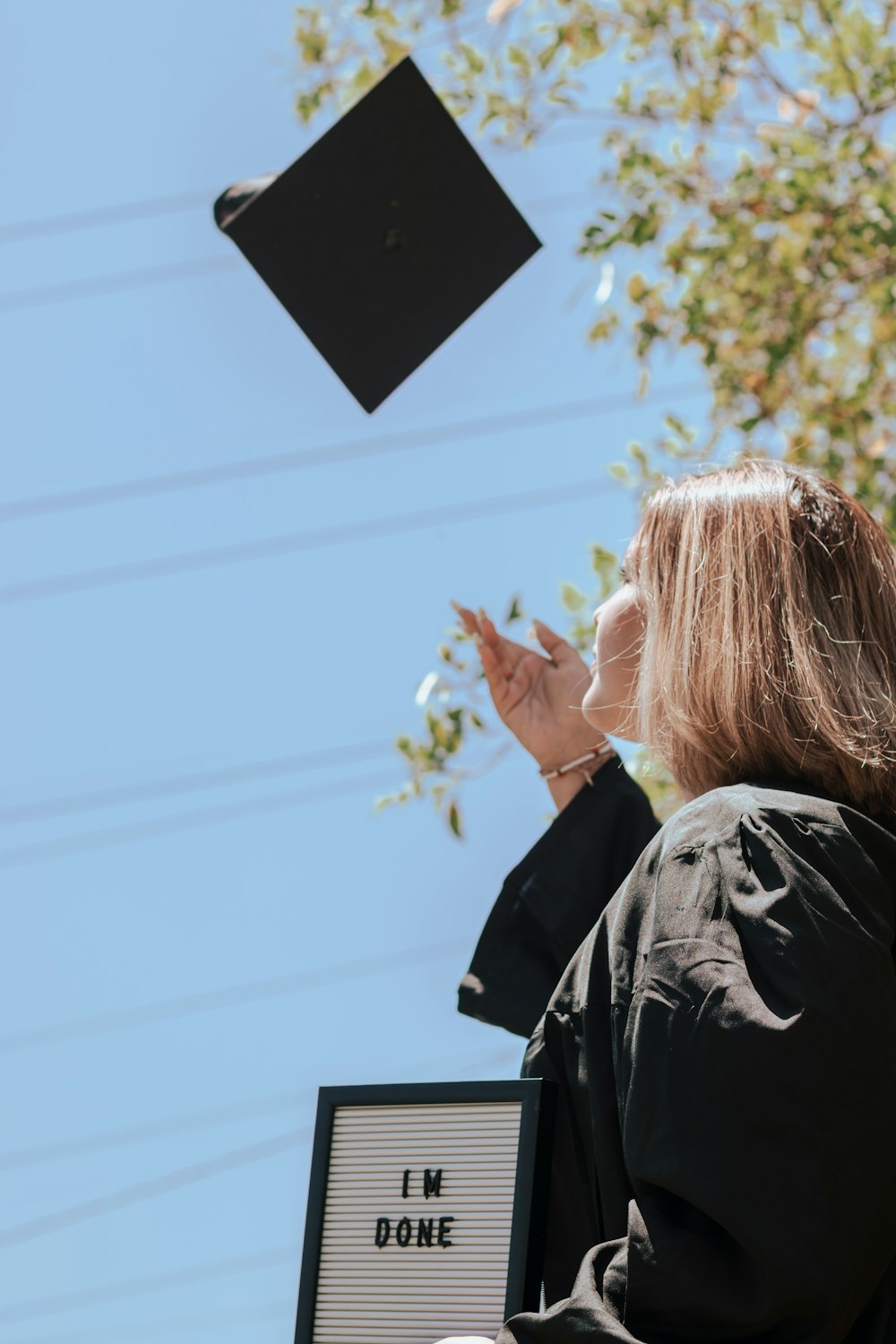 a person holding a black sign