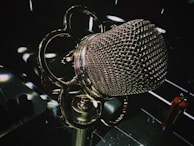 Close-up of a vintage microphone with a soft spotlight highlighting its texture.