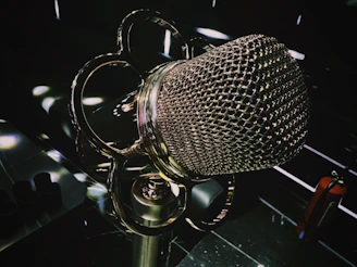 A close-up of a vintage microphone glowing softly with magical runes swirling around it.