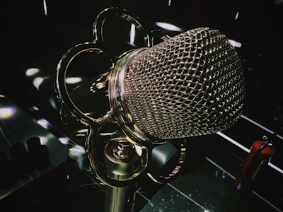 Close-up of a vintage microphone with dark, luxurious studio backdrop